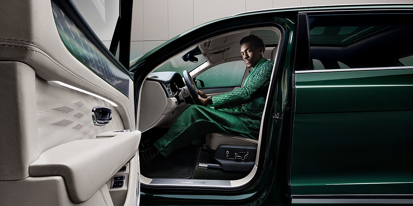 Bentley Casablanca Wisdom K seated in Bentley Bentayga Extended Wheelbase SUV in Light Emerald green paint with door open