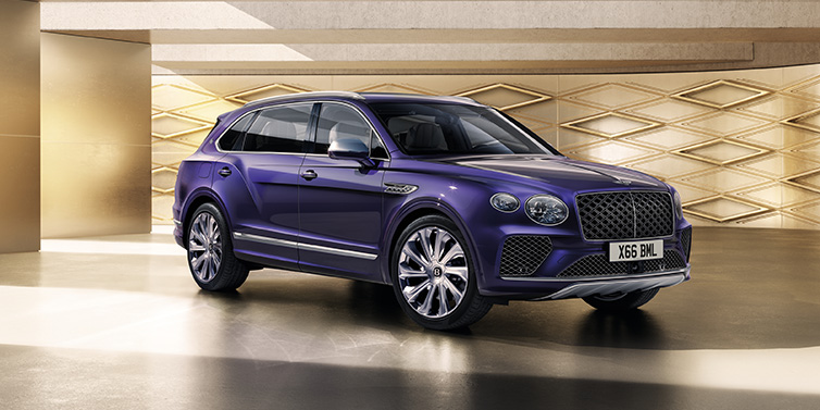 Bentley Casablanca Bentley Bentayga Extended Wheelbase Mulliner SUV front three quarter in Tanzanite Purple paint with a gold patterned background