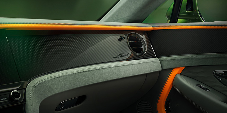 Bentley Casablanca Bentley Continental GT Speed coupe front interior dash detail with high gloss carbon fibre veneer surrounded by Mandarin by Mulliner and Gravity Grey hides
