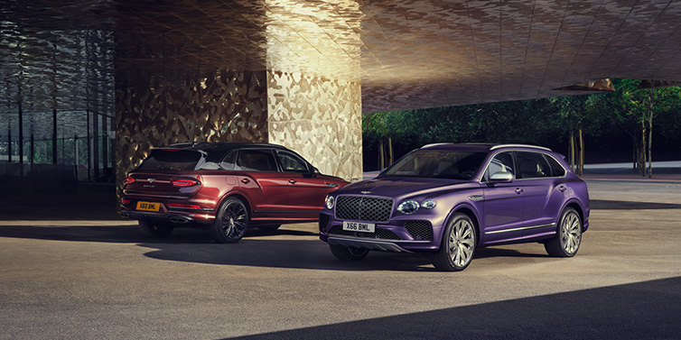 Bentley Casablanca A duo of Bentley Bentayga Extended Wheelbase Mulliner SUVs parked in a city environment, with Tanzanite Purple and Cricket Ball red exterior paint