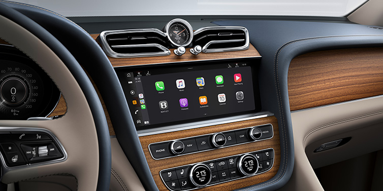 Bentley Casablanca Bentley Bentayga Extended Wheelbase Azure SUV front interior centre console with MMI screen showing apps, surrounded by Portland and Imperial Blue coloured hides