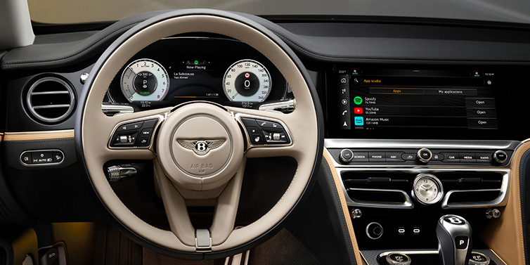 Bentley Casablanca Bentley Flying Spur Mulliner sedan front interior detail of steering wheel and driver screens surrounded by Linen and Beluga black hides
