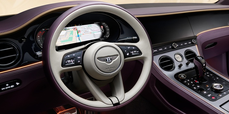 Bentley Casablanca Bentley Continental GT Mulliner coupe front interior showing steering wheel and drivers screens surrounded by Linen and Damson hides and Grand Black veneer